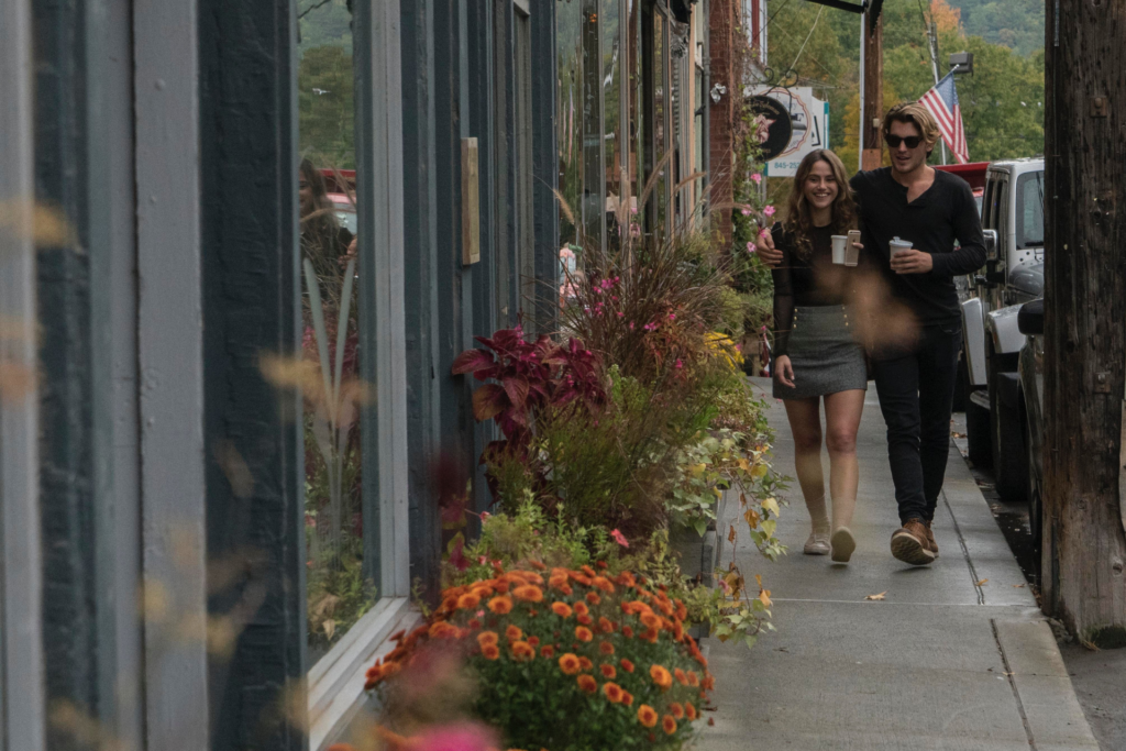 A man and woman walking down a sidewalk