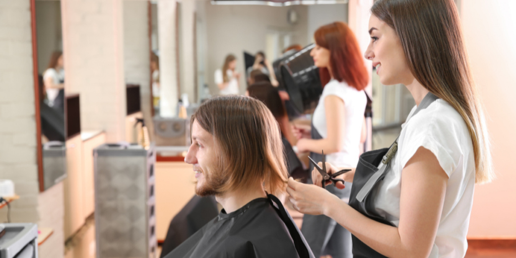 Woman cutting a man's hair