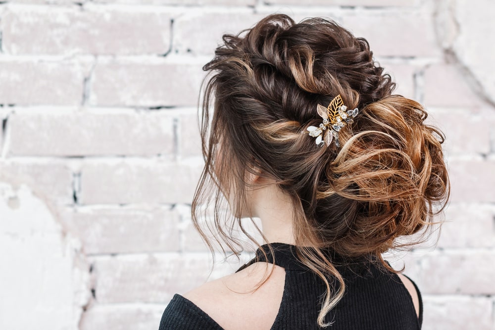 A woman with a braid and bun updo.