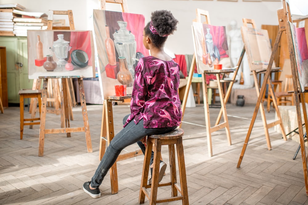 Woman painting in an art class.