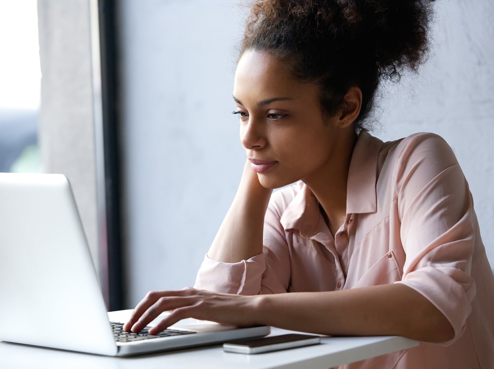 woman sitting at a computer smiling