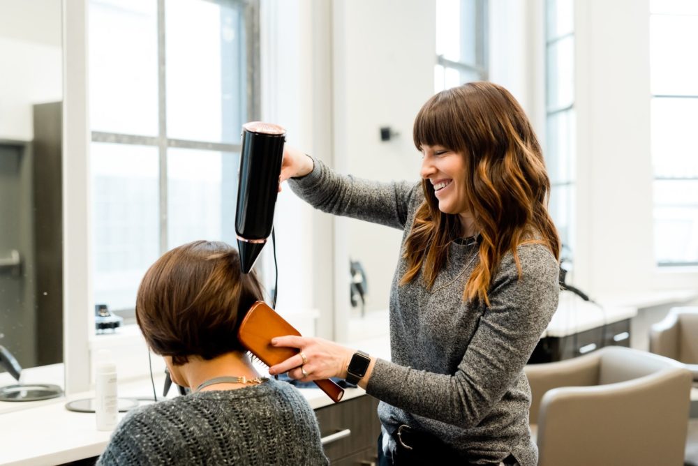 Woman blowdrying hair