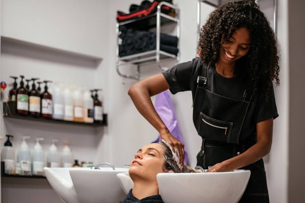 Woman washing someone's hair.