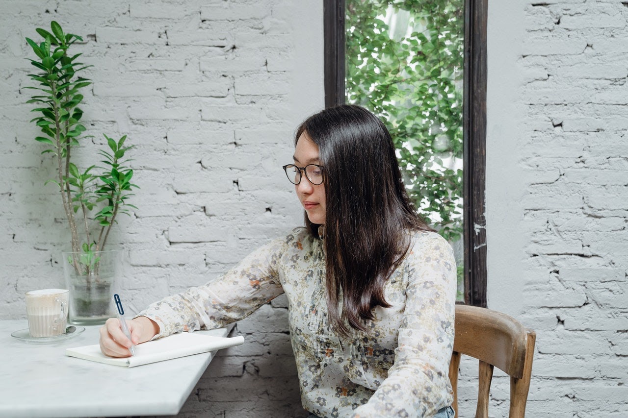 woman writing in a planner