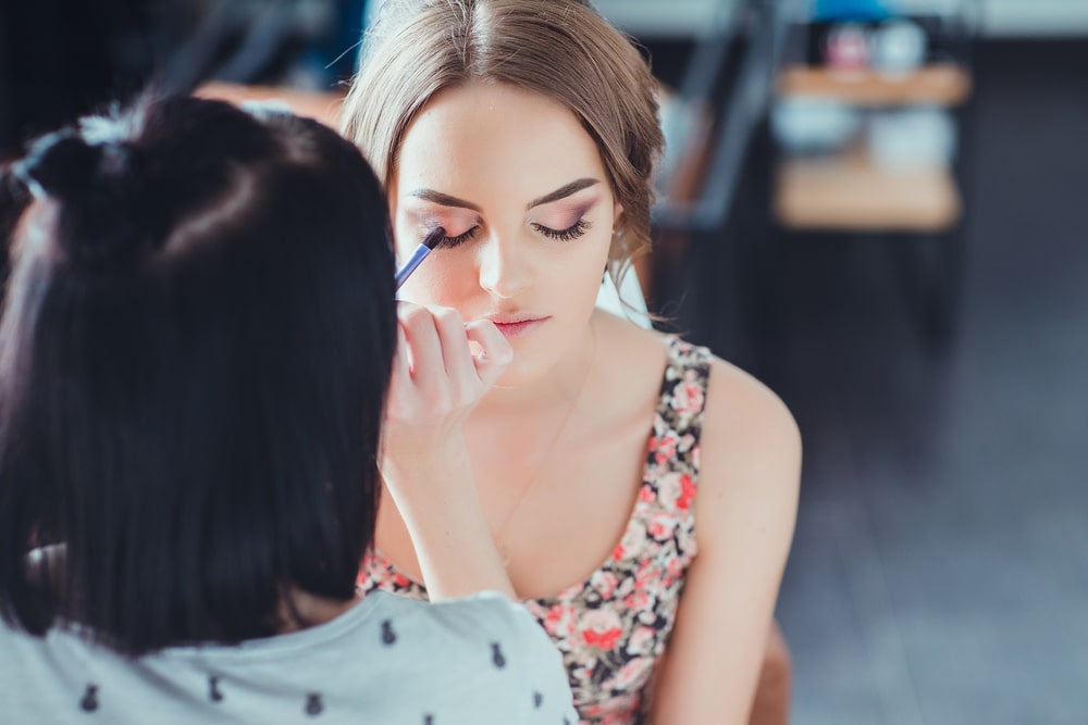 woman doing another woman's makeup