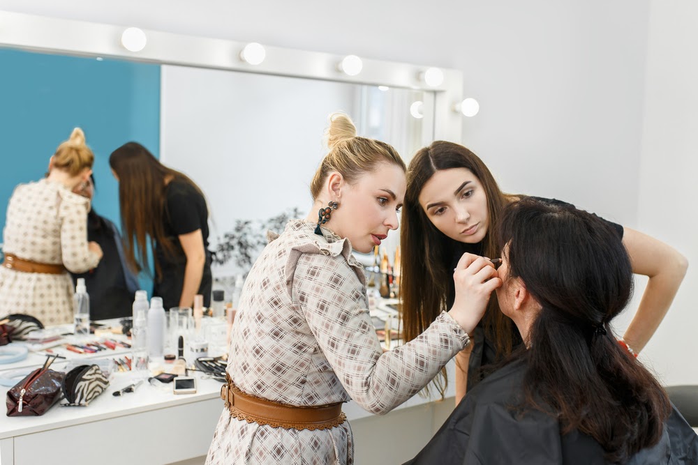 a teacher and a student learning to do makeup